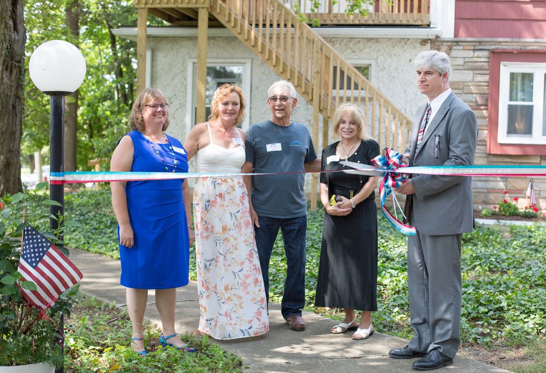 Board members and community leaders cut the ribbon at the dedication of Newbridge Veterans Place